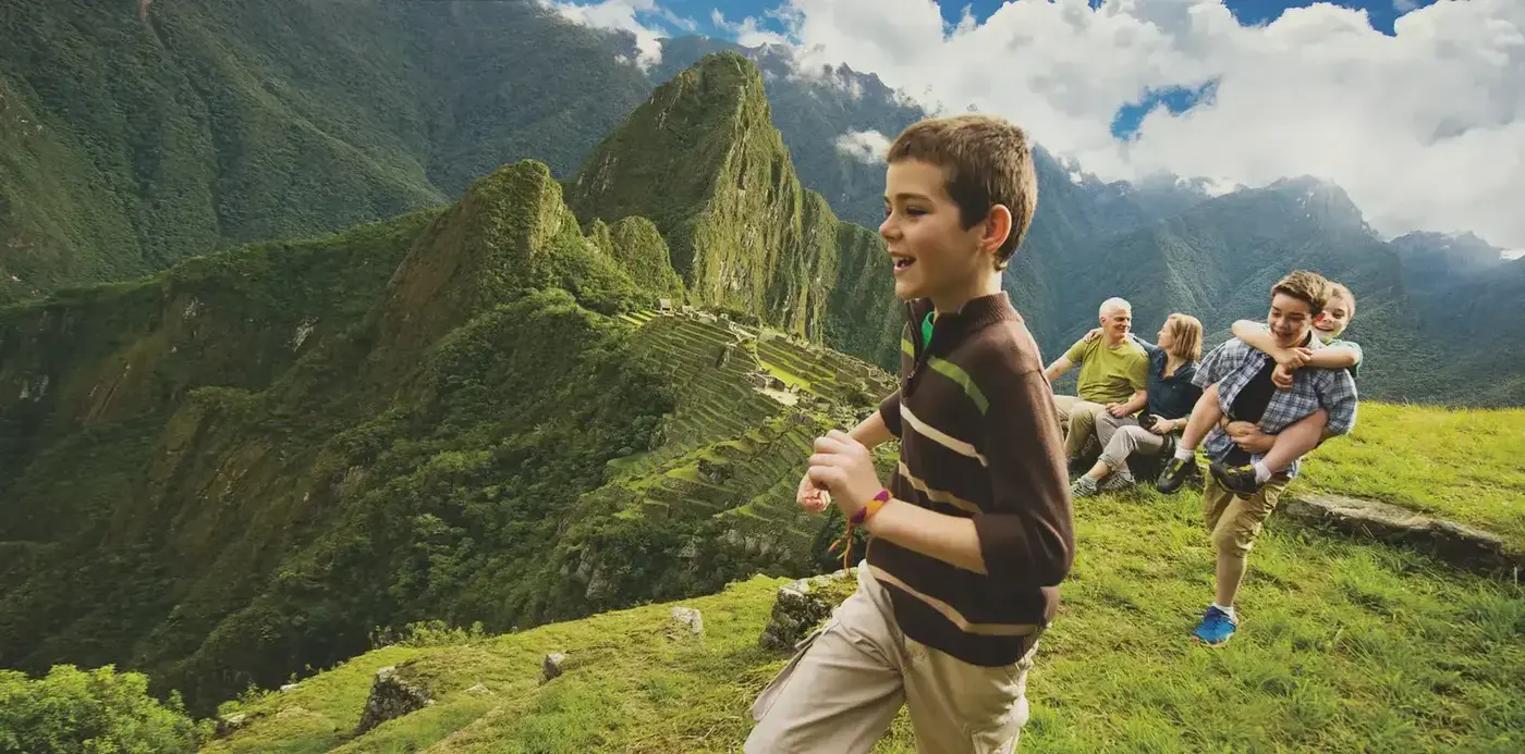 A guide and travelers overlooking Machu Picchu.