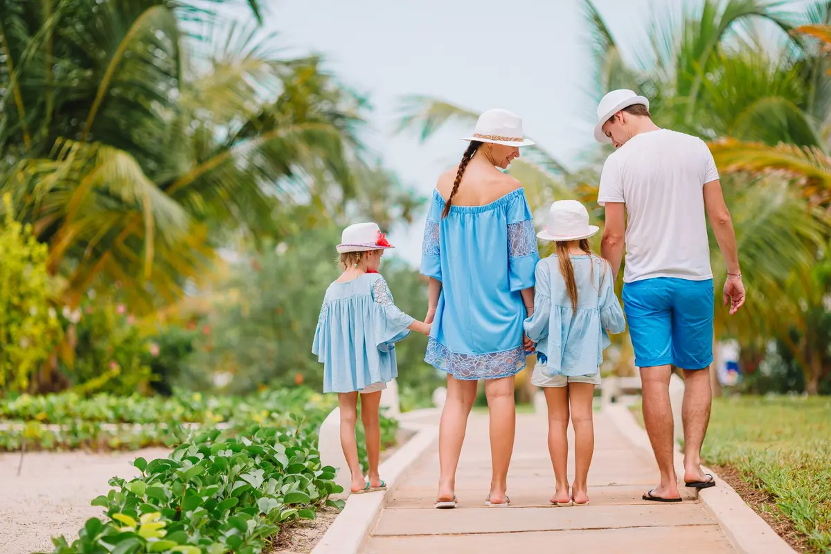 A family walking together along a tropical resort path