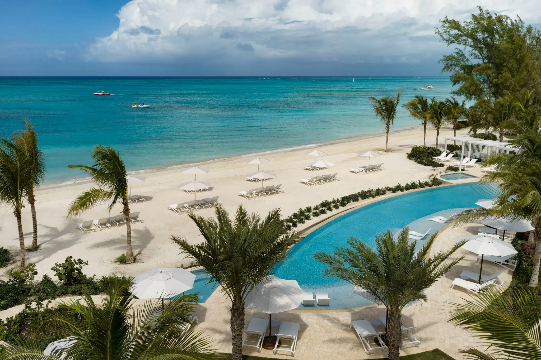 A pool overlooking the beach and turquoise sea at Beaches Turks & Caicos