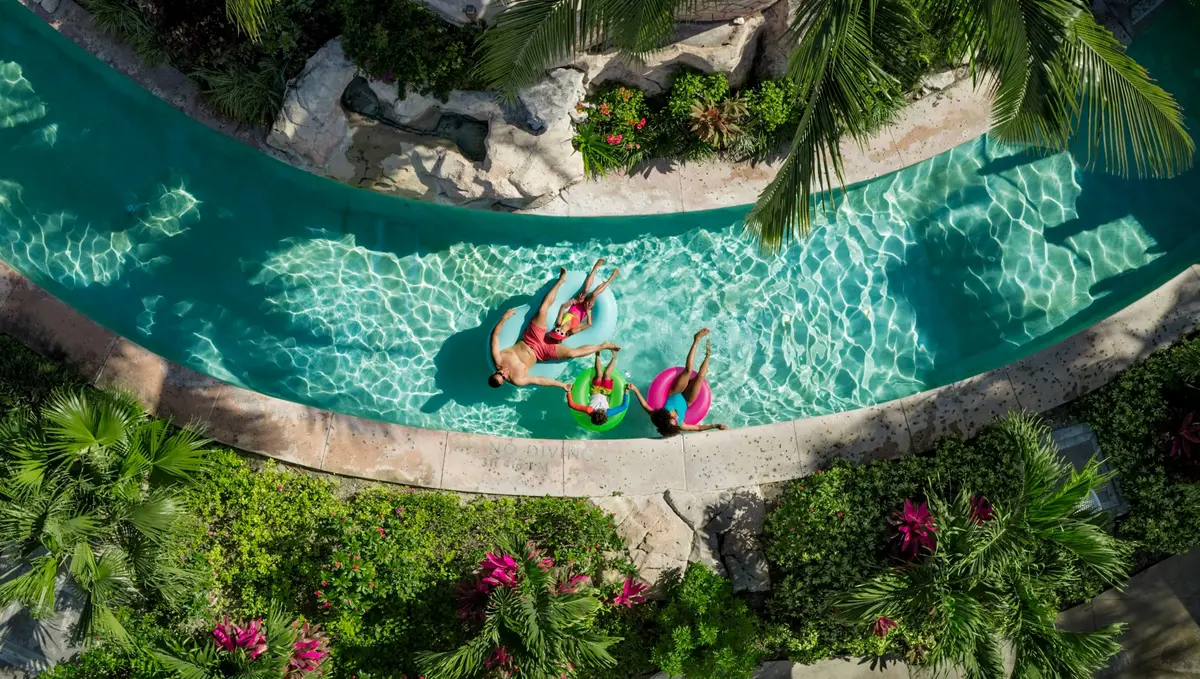 A family floating together along the lazy river at Beaches Turks & Caicos