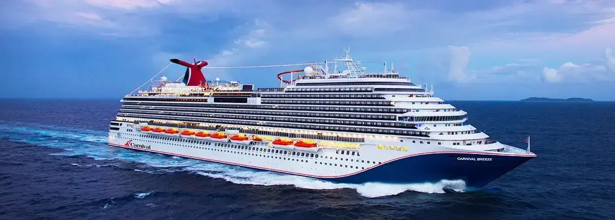 A Carnival cruise ship sailing on open water.