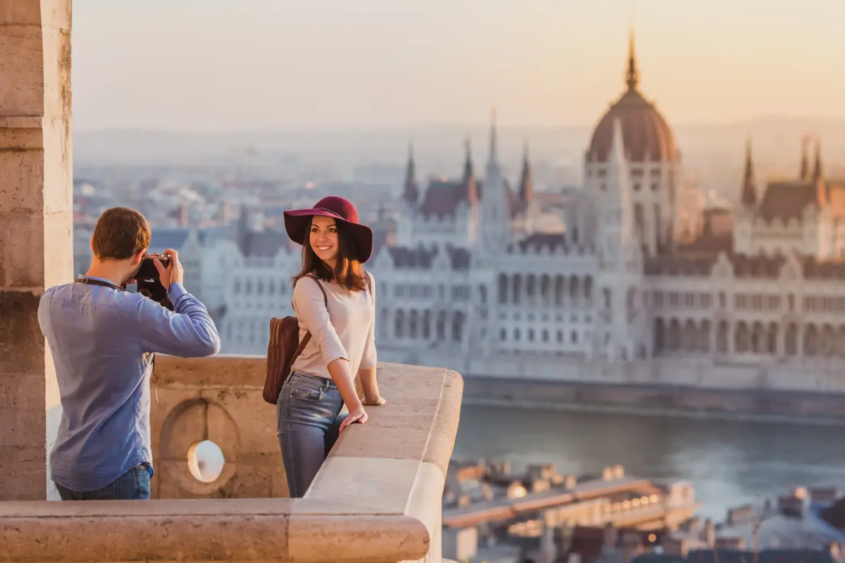 A couple taking photographs overlooking Budapest