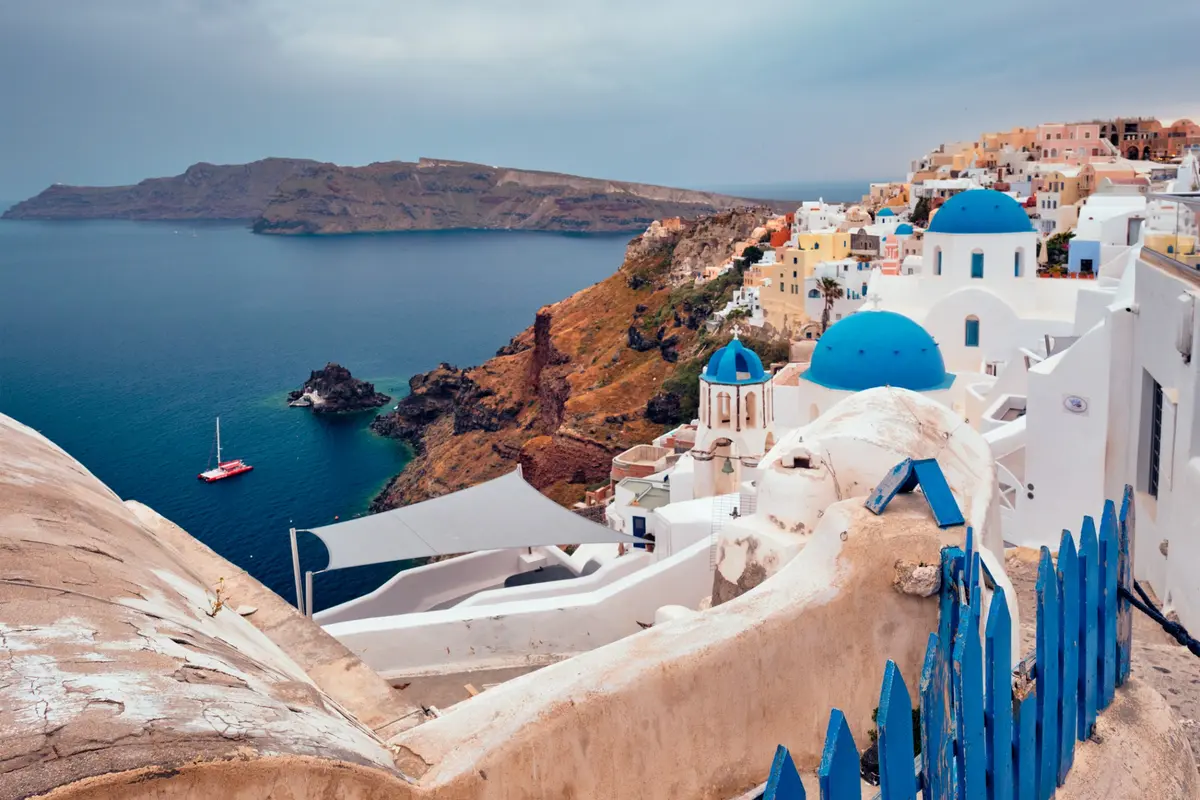 Blue domes and whitewashed buildings above the sea in Oia, Greece