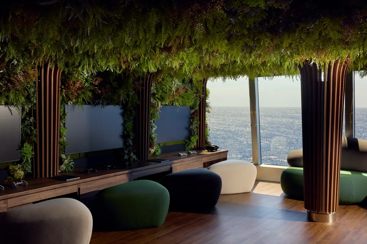 The Nautilus Lounge with leafy walls, curved seats, and a view of the sea