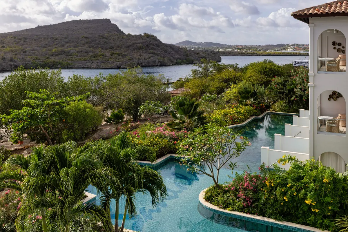 A curving pool beside Sandals swim-up suites and tropical gardens