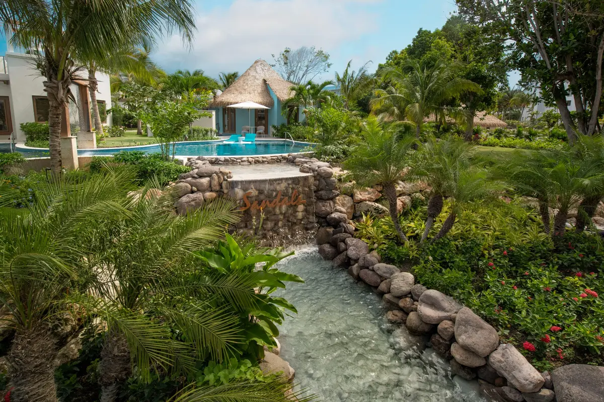 Swim-up Rondoval suites and a cascading pool at Sandals Dunn’s River
