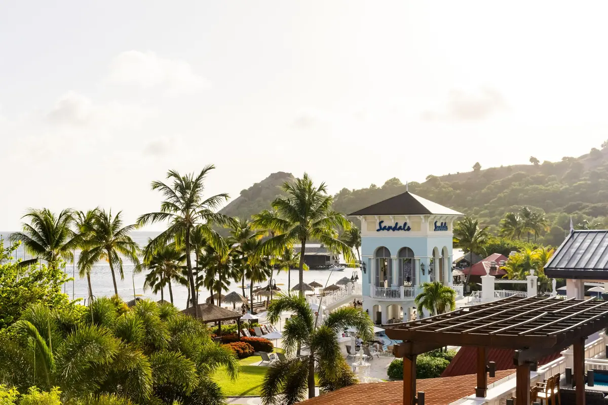 Palms, gardens, and the pool tower at Sandals Grande St. Lucian