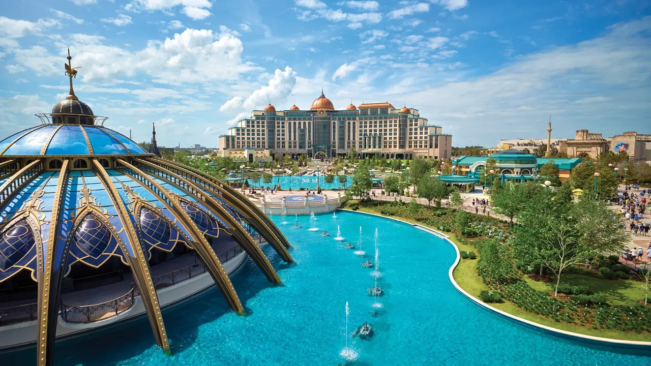 A resort pool with Universal Epic Universe in the distance.