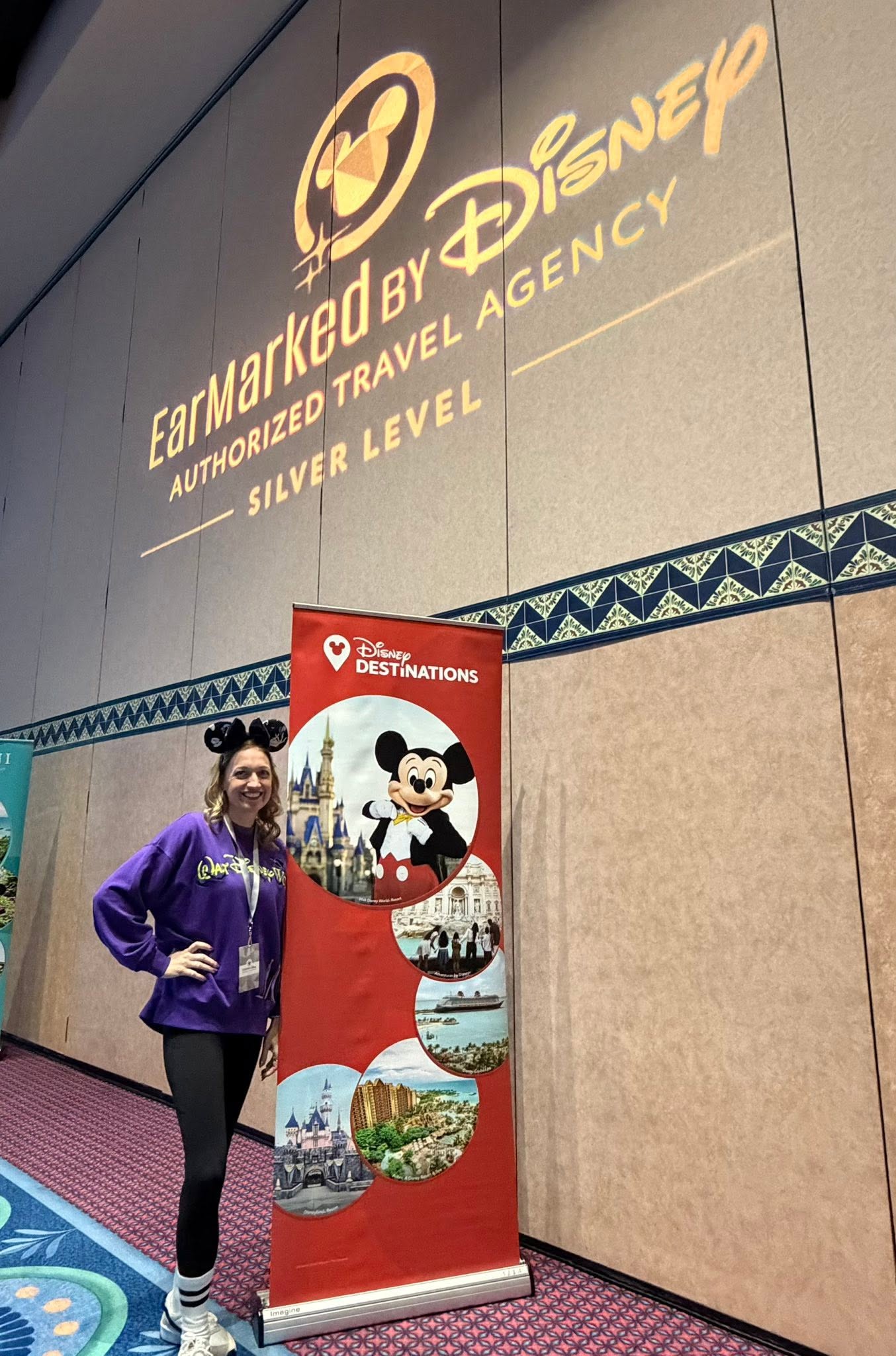 An advisor beneath an EarMarked by Disney event projection