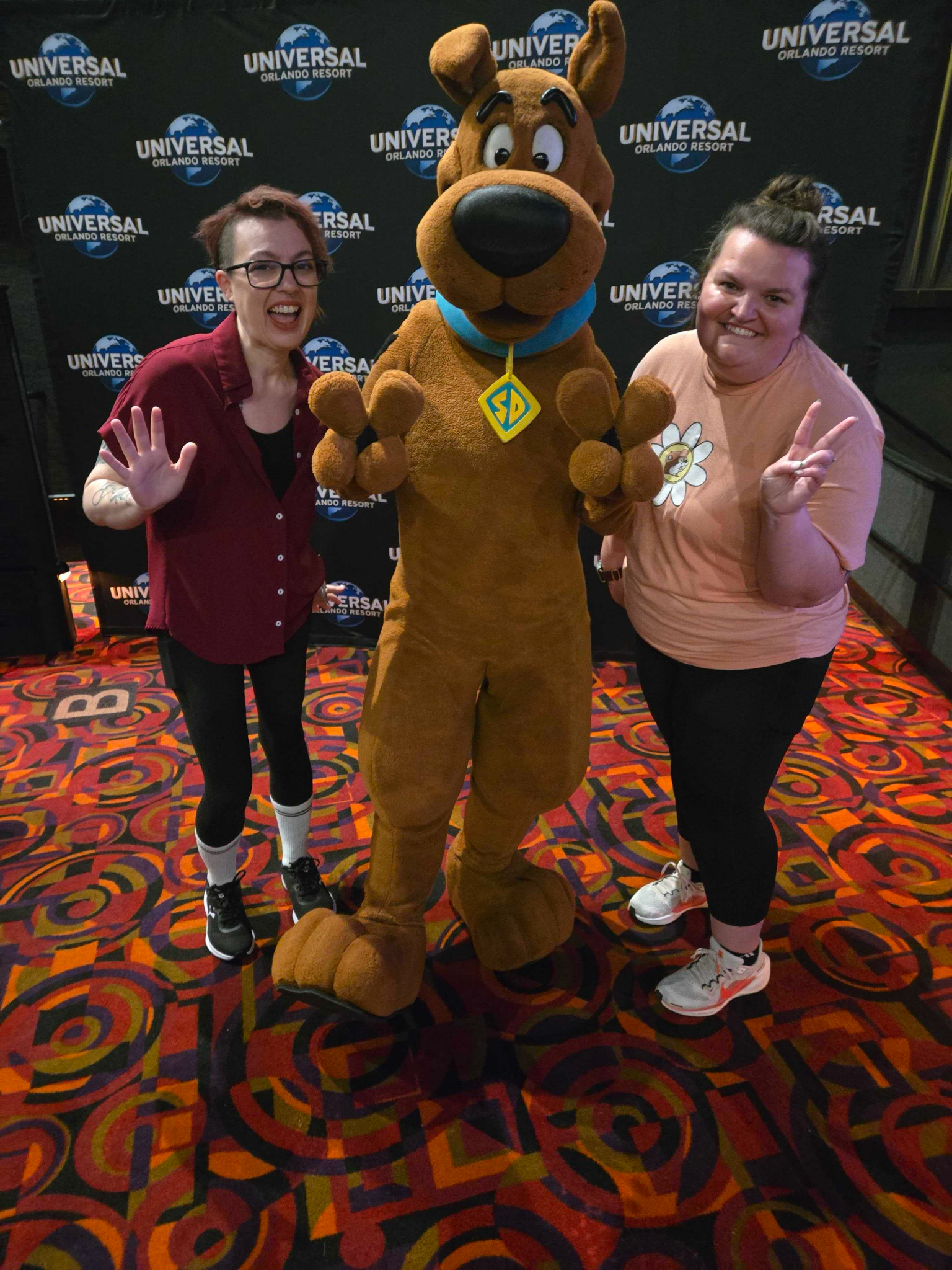 Two advisors with Scooby-Doo at a Universal Orlando event