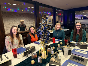 Wand & Compass advisors seated together at a dinner table