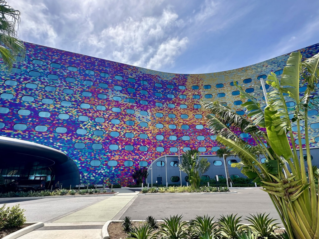 Colorful Universal Orlando hotel facade framed by tropical landscaping.
