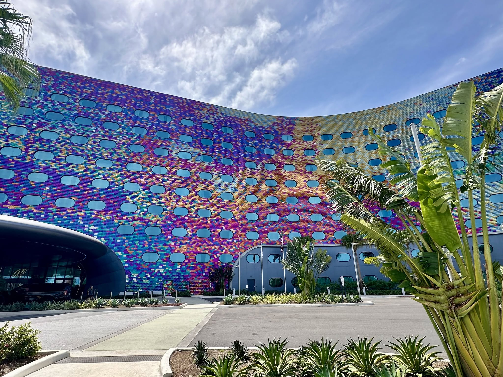 Colorful Universal Orlando hotel facade framed by tropical landscaping.